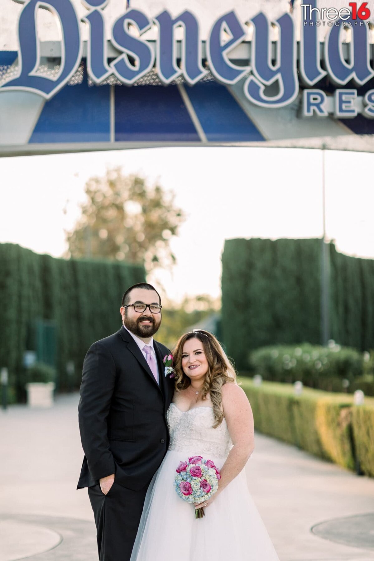 Bride and Groom pose together for the wedding photographer