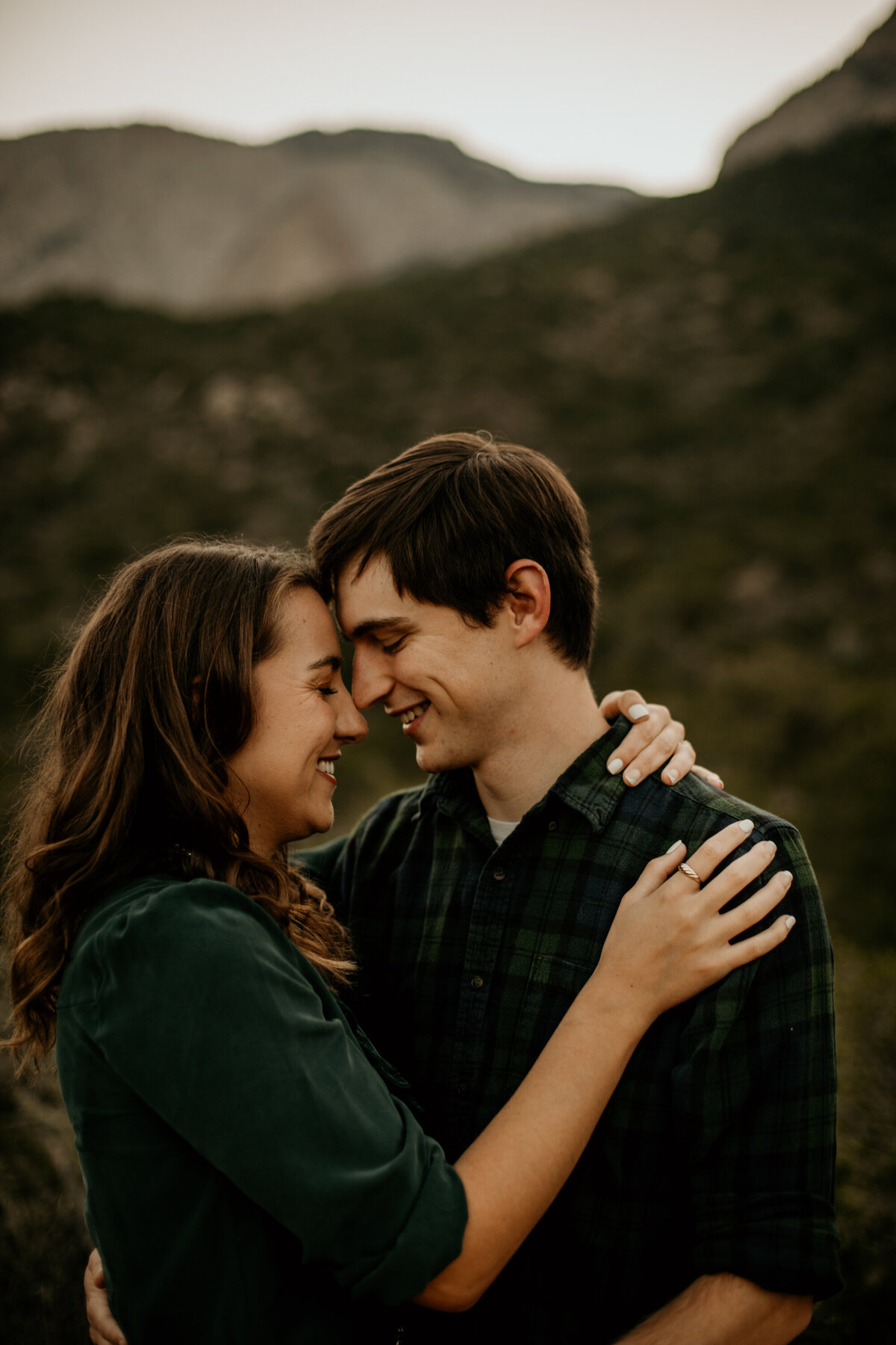 engaged couple with foreheads together at the foothills in Albuquerque