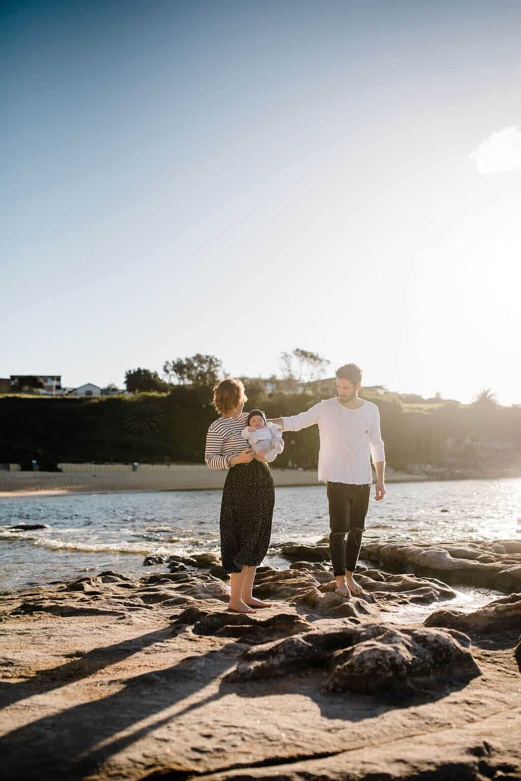 Young-family-playing-with-baby-at-Maroubra-beach-during-golden-hour