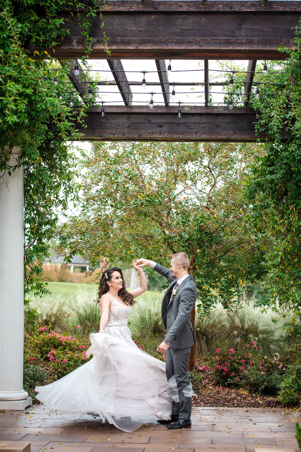Russian bride and groom dancing outdoors under the pergola at the Ballantyne Hotel by Charlotte wedding photographers DeLong Photography