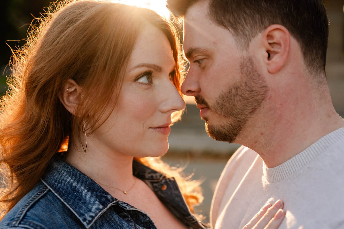 A couple stare at each other nose to nose at sunset.