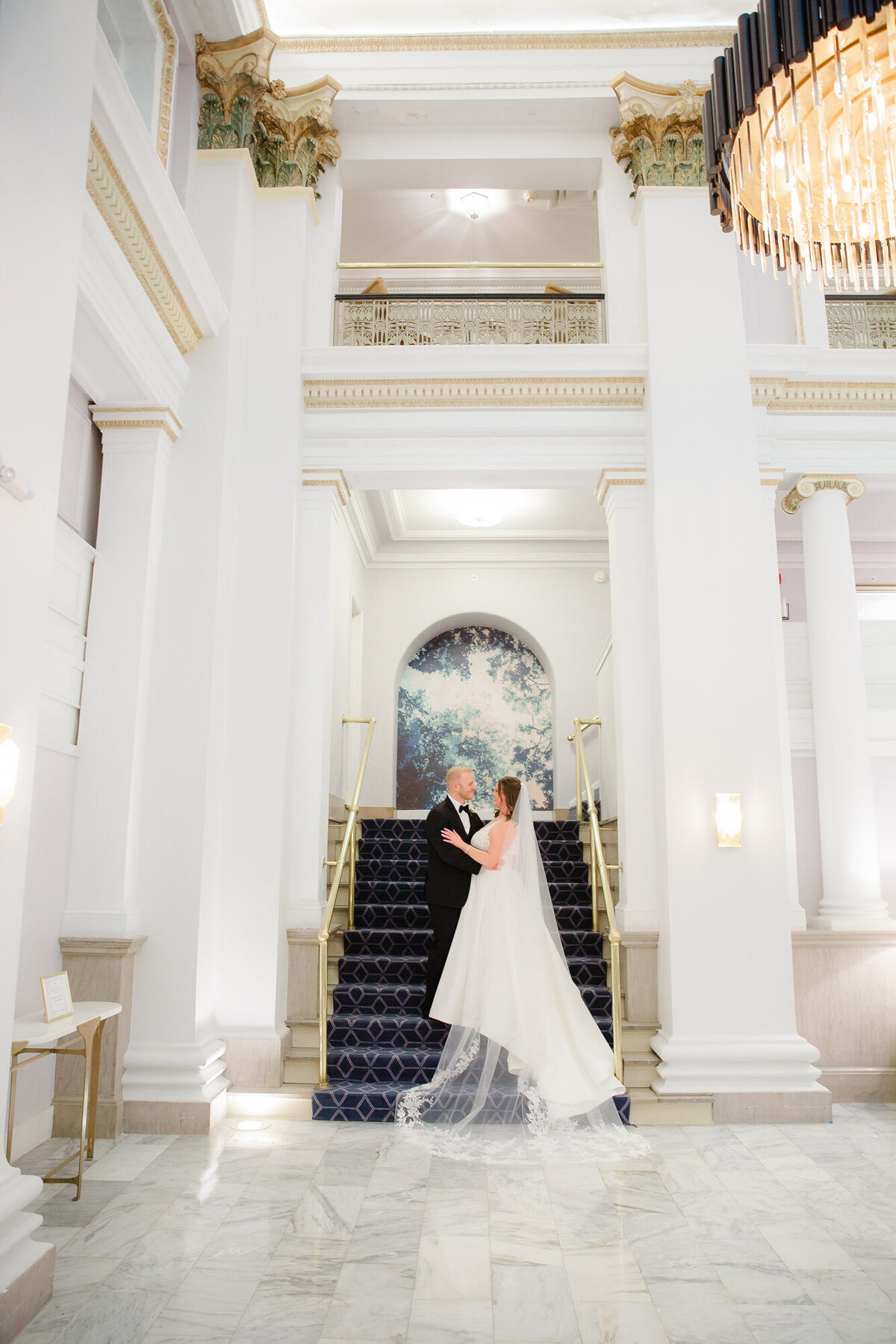 bride and groom on the stairs at the Westin Great Southern in Columbus, Ohio