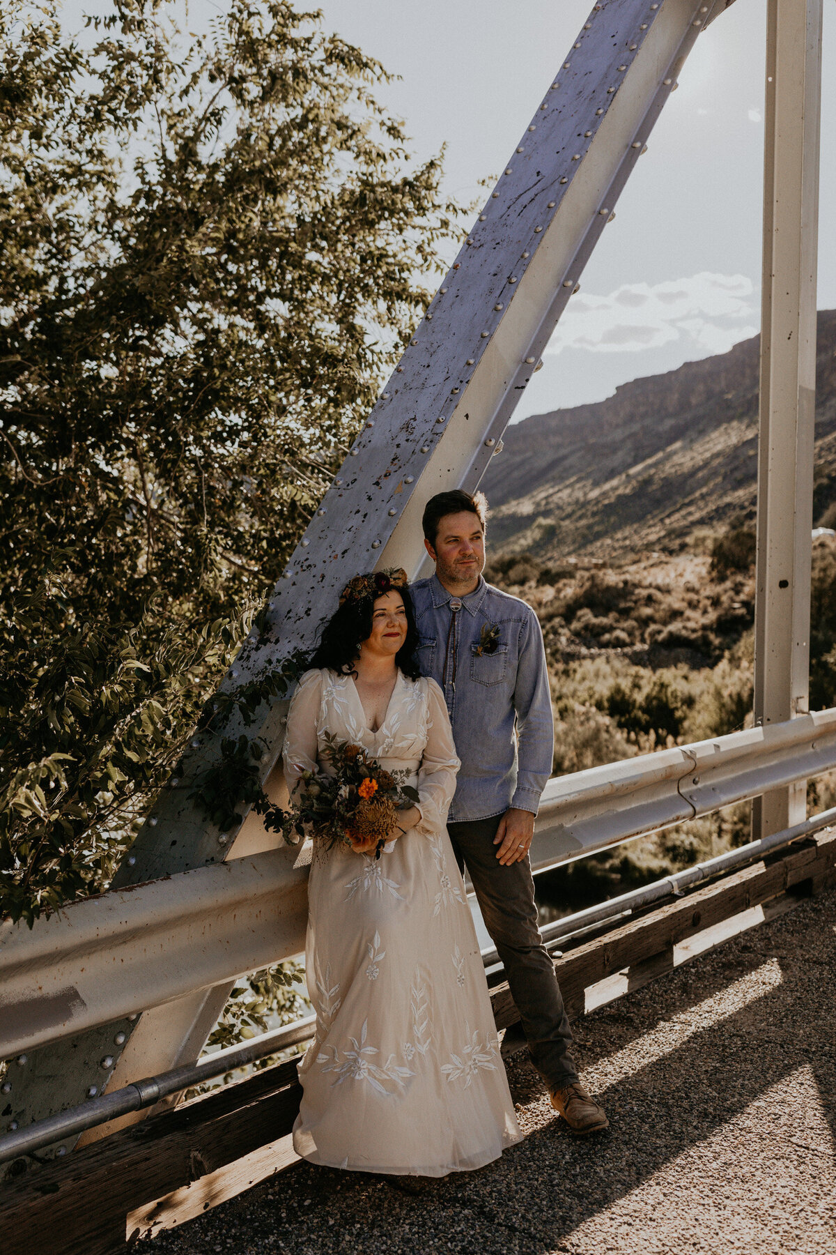 newlyweds standing on a bride above the Rio Grade in New Mexico