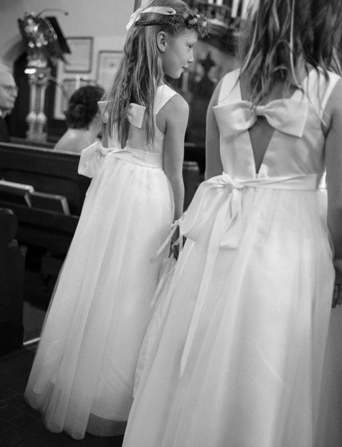 bow details on the back of flower girl dresses during a wedding ceremony at Christ Church, Detroit