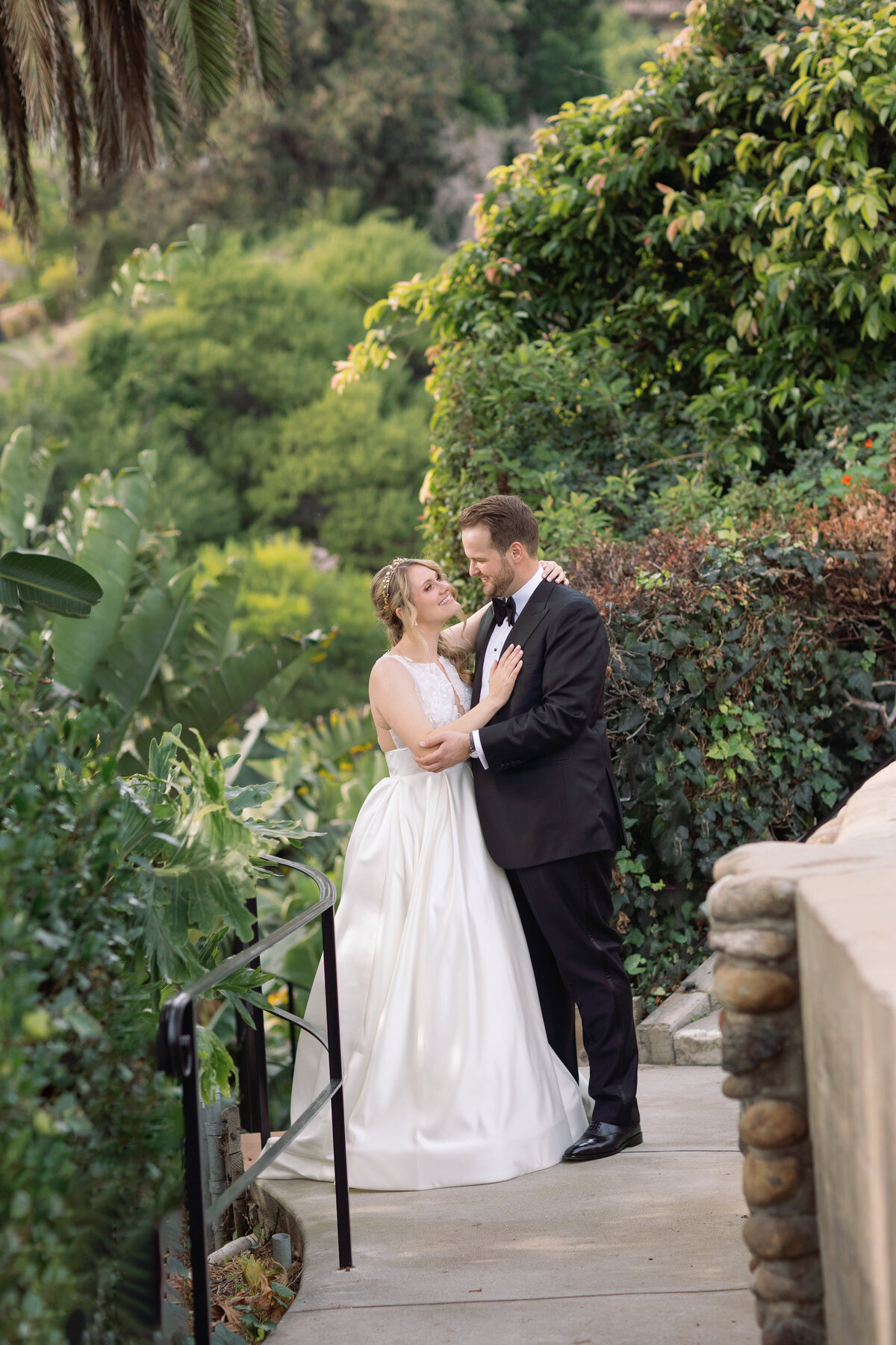 Couple taking photos on the lush gardens at Bel Air Bay Club