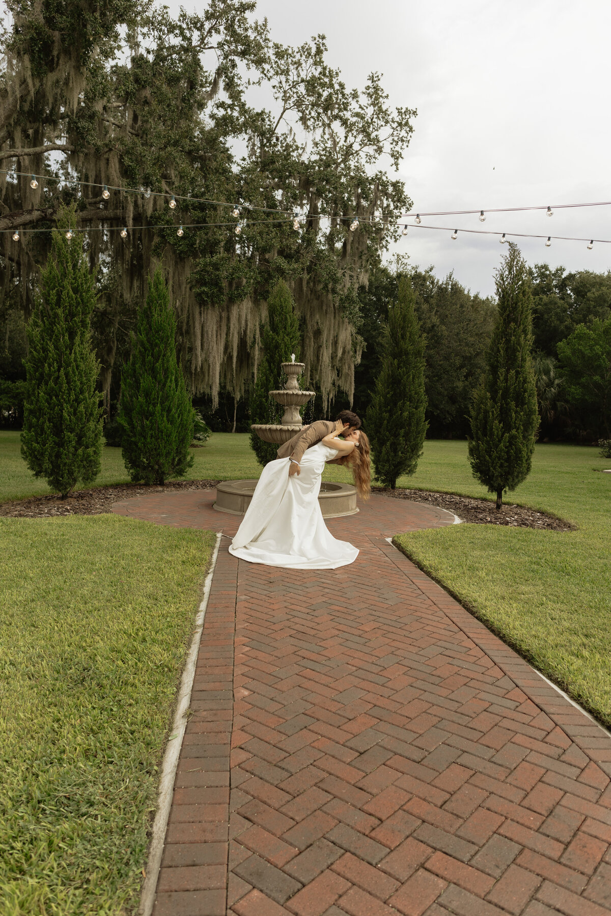Romantic backyard wedding at The Palm Mansion in Umatilla, Florida with lush palm trees and floral arch