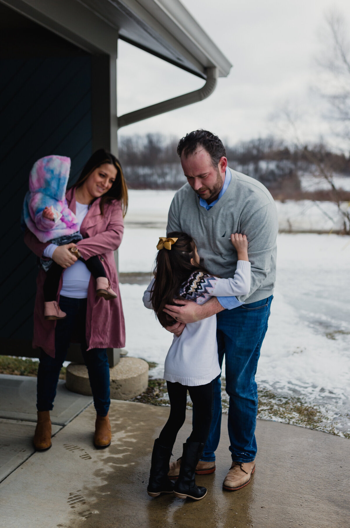 Maternity and family photoshoot with mom, dad, and two young girls.