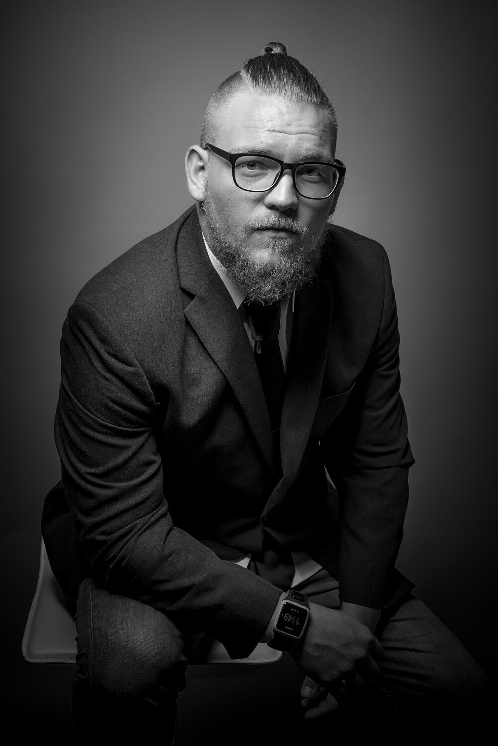 Dramatic studio headshot captured on a grey backdrop at an Austin portrait studio.