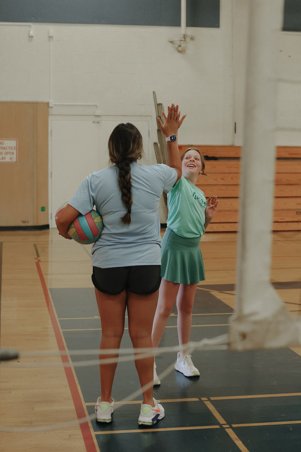 Coach high fiving during volleyball