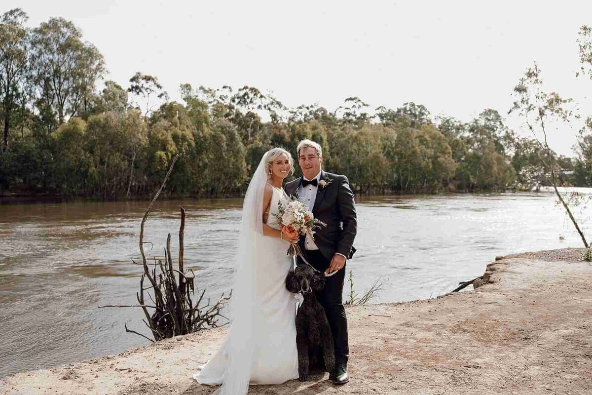 bride_groom_standing_with_dog