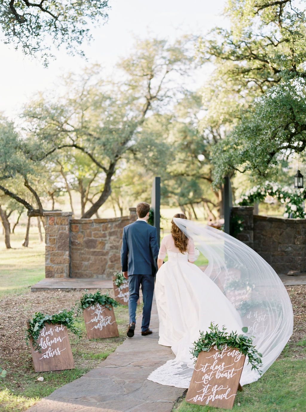 couple walking to grove, veil