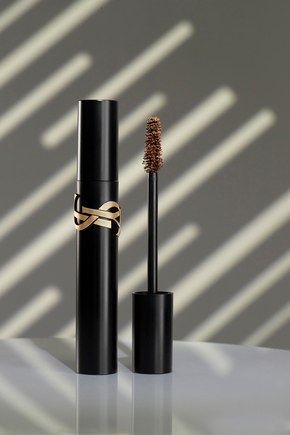 YSL mascara with sleek black and gold packaging, photographed by Ylva Erevall.