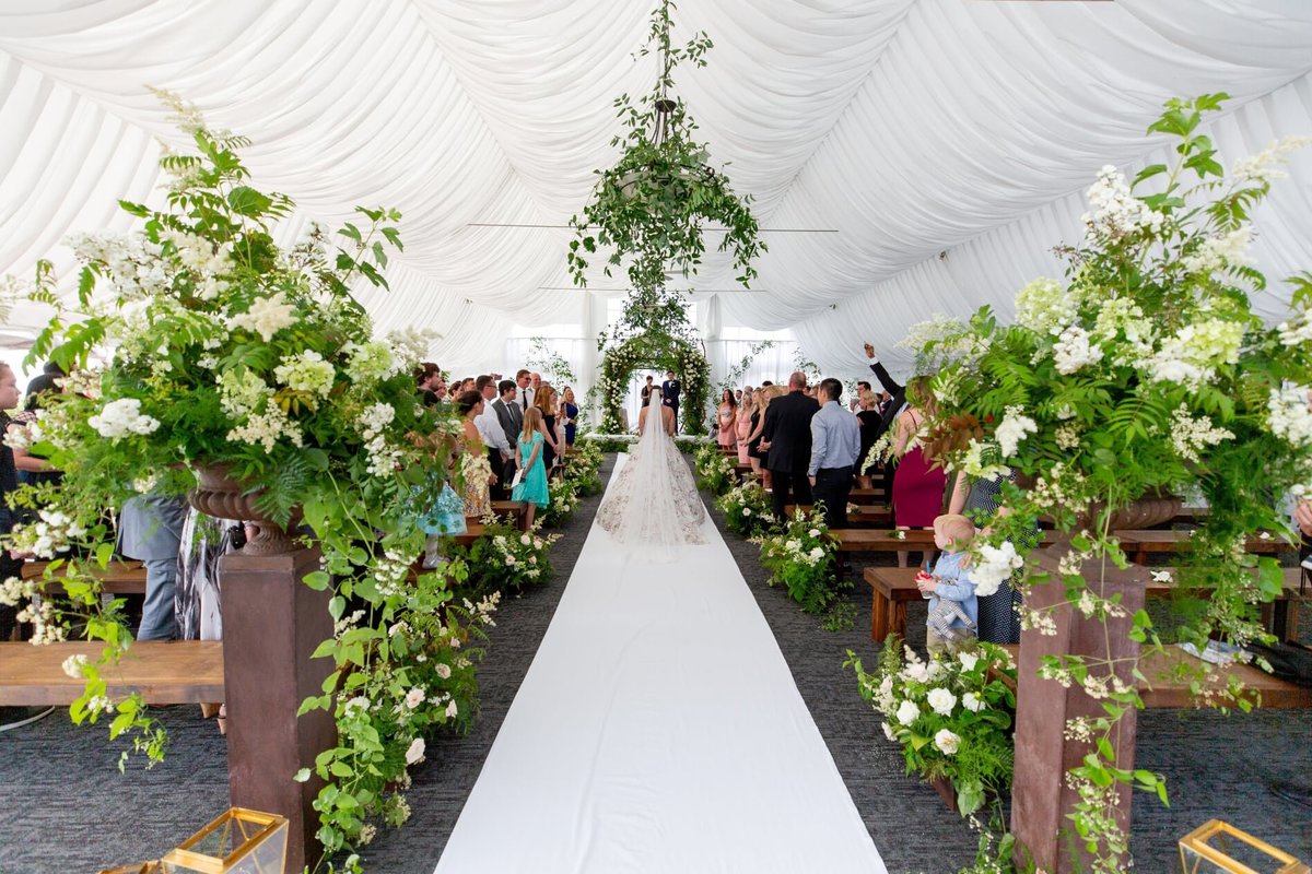 Wedding aisle lined in lush greenery floral centerpieces at Newcastle wedding - Flora Nova Design Seattle