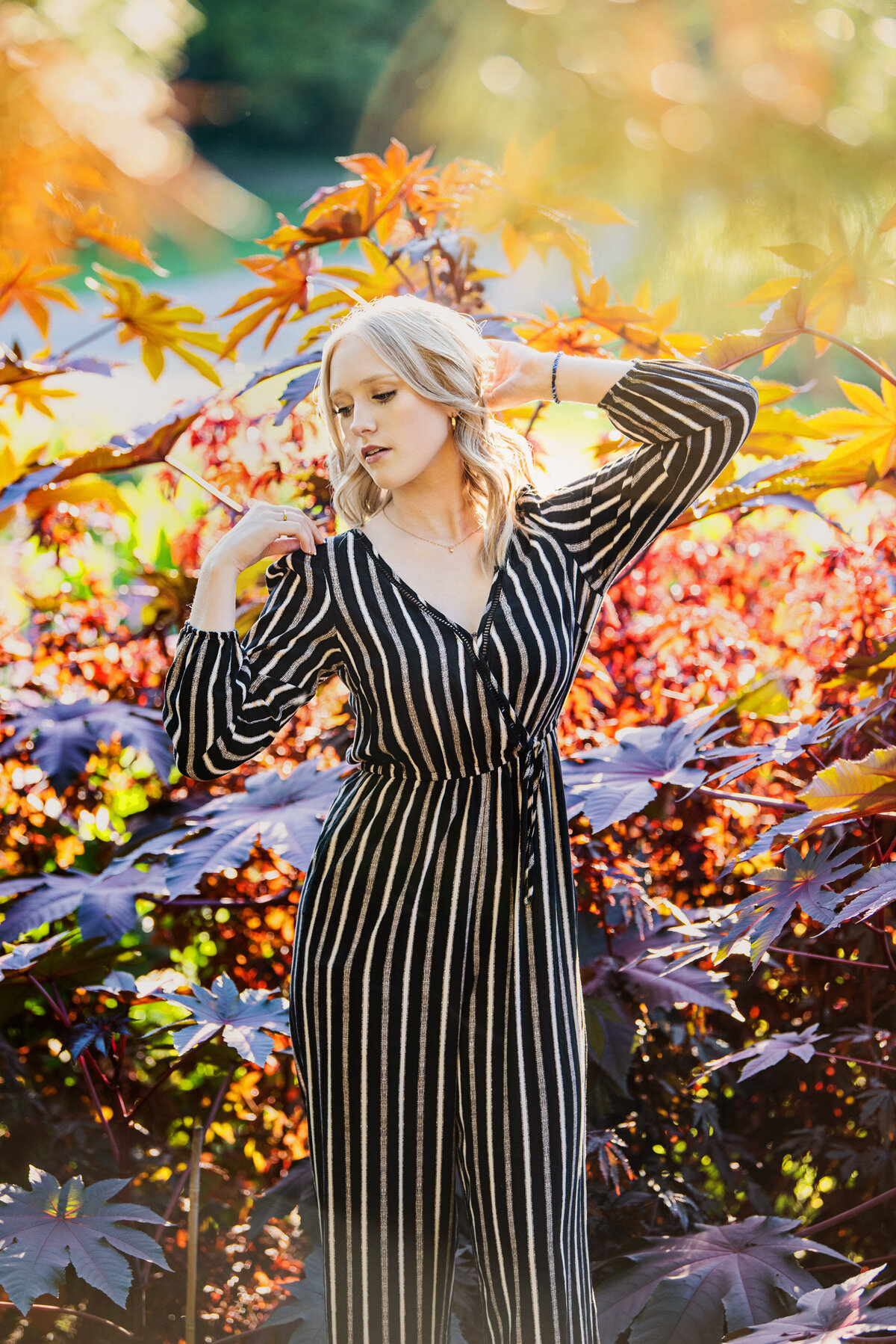 girl in colorful leaves in black and white outfit