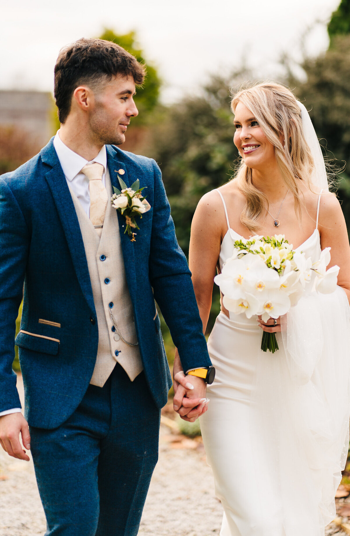 Bride and groom walking through gardens at Mytton Fold Hotel taken by Anthony Horseman wedding photographer
