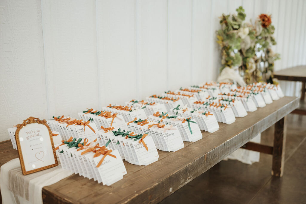 Fargo, ND wedding escort cards custom design and satin ribbons with gold sign