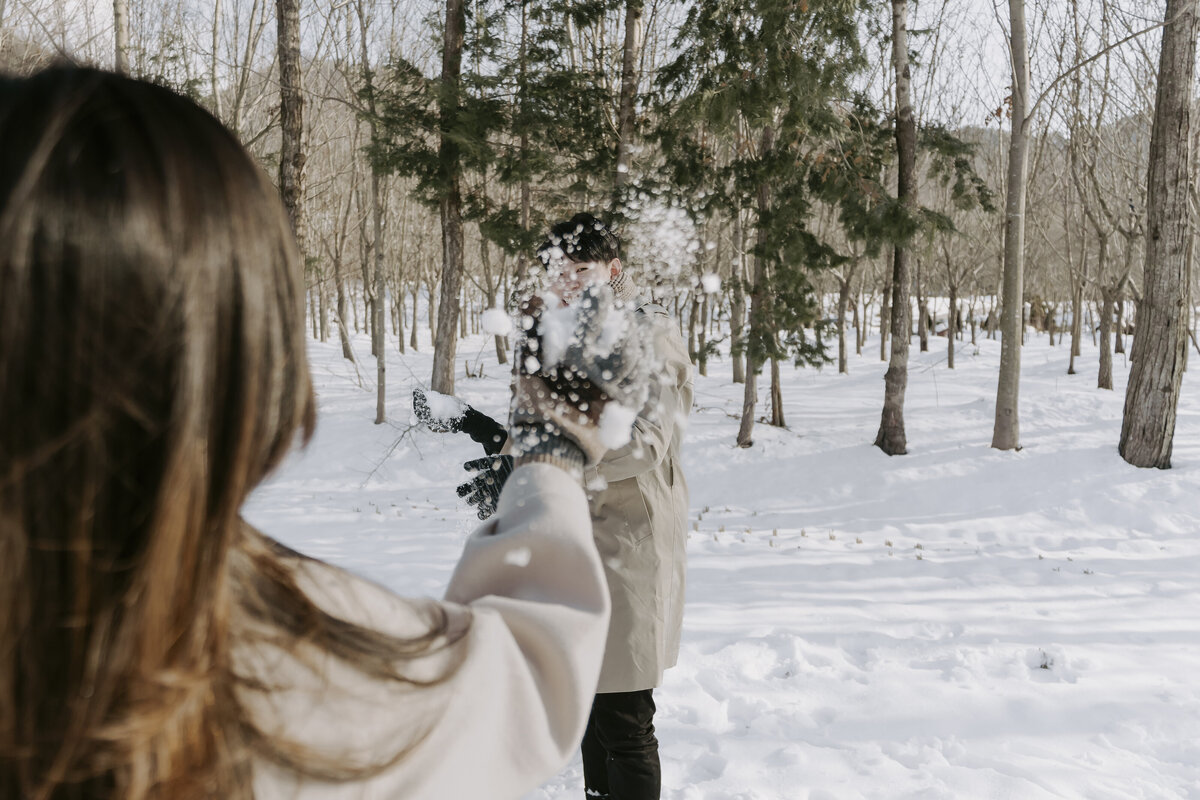 the bride also throws snow at the groom