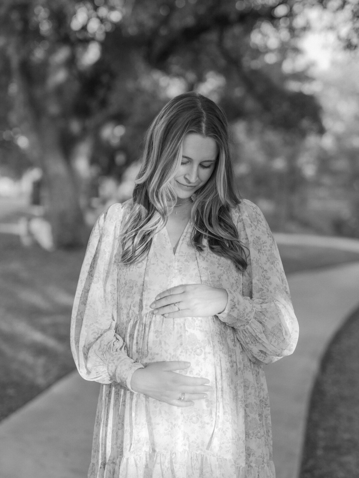 Pregnant mom looking at belly photo by Lauren Bounds, Colorado Spring Maternity Photographer