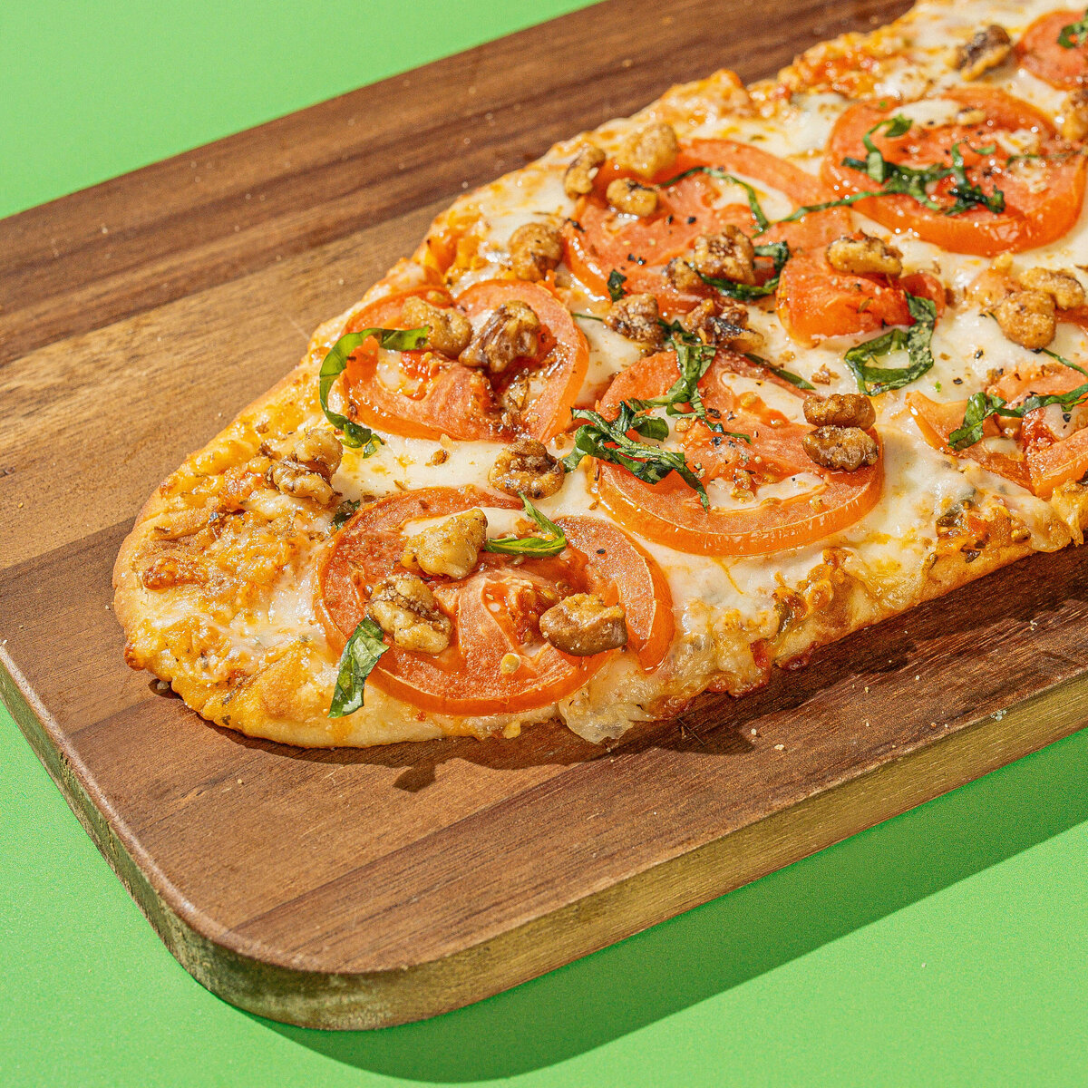 Pizza food product photography on a green backdrop in Greenville, SC