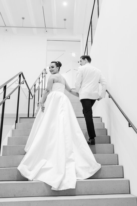 bride-and-groom-walking-up-stairs-at-museum-of-contemporary-arts-san-diego-wedding