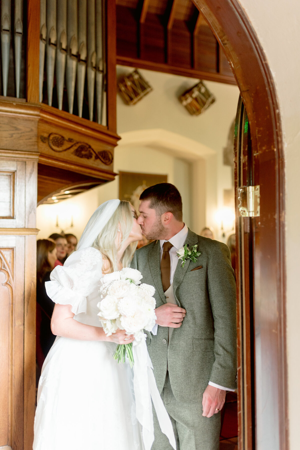 Cromlix House Chapel entrance with Bride and Groom kiss as they leave as newlyweds.