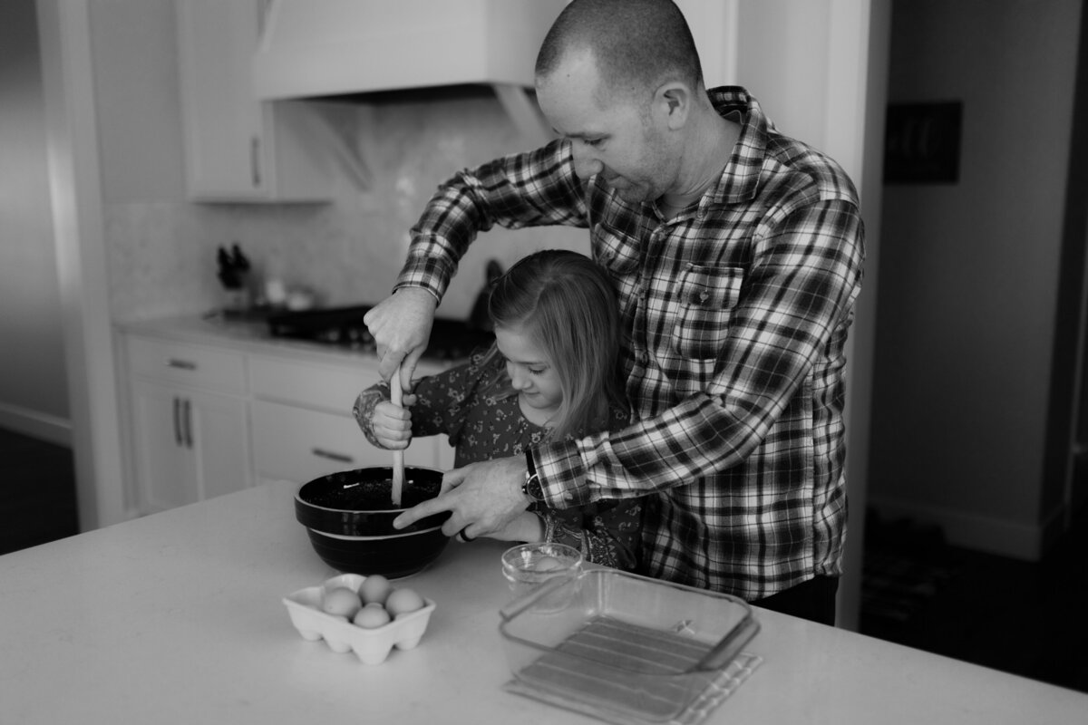 black and white image father helping daughter