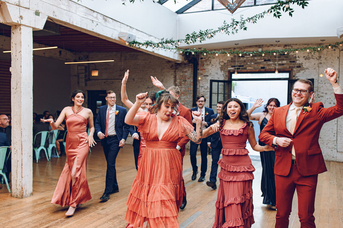 A wedding party dances their way to their tables at a wedding at The Joinery in Chicago