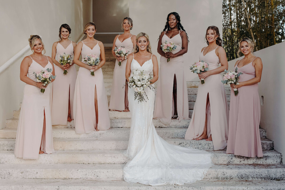 Elegant bridal hair and makeup for this glowing bride, paired with soft glam looks for her bridesmaids. Nails by our San Antonio nail salon complete the polished wedding party style.