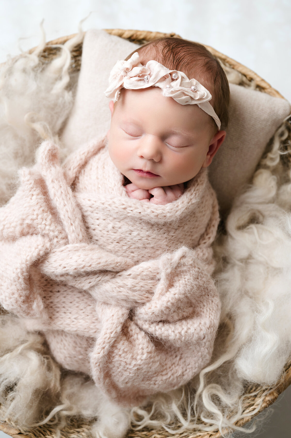 Capture the peaceful innocence of your newborn with a beautiful, soft-knit blanket wrap in our Pittsburgh newborn photography studio. Perfect for creating timeless memories with your little one.
