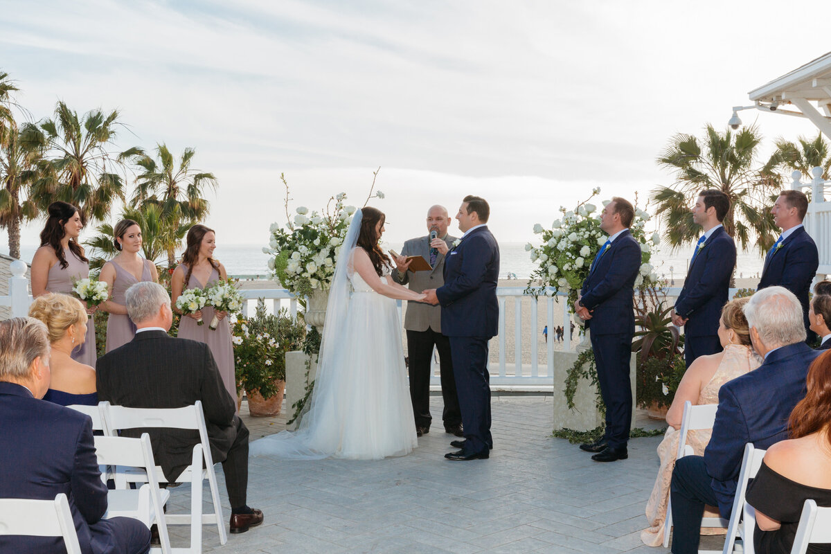 A bride and groom holding hands during their vows