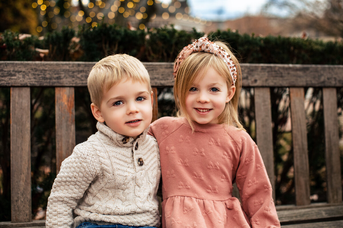 Young blonde siblings hug on a bench during family mini sessions in Sewickley Pennsylvania