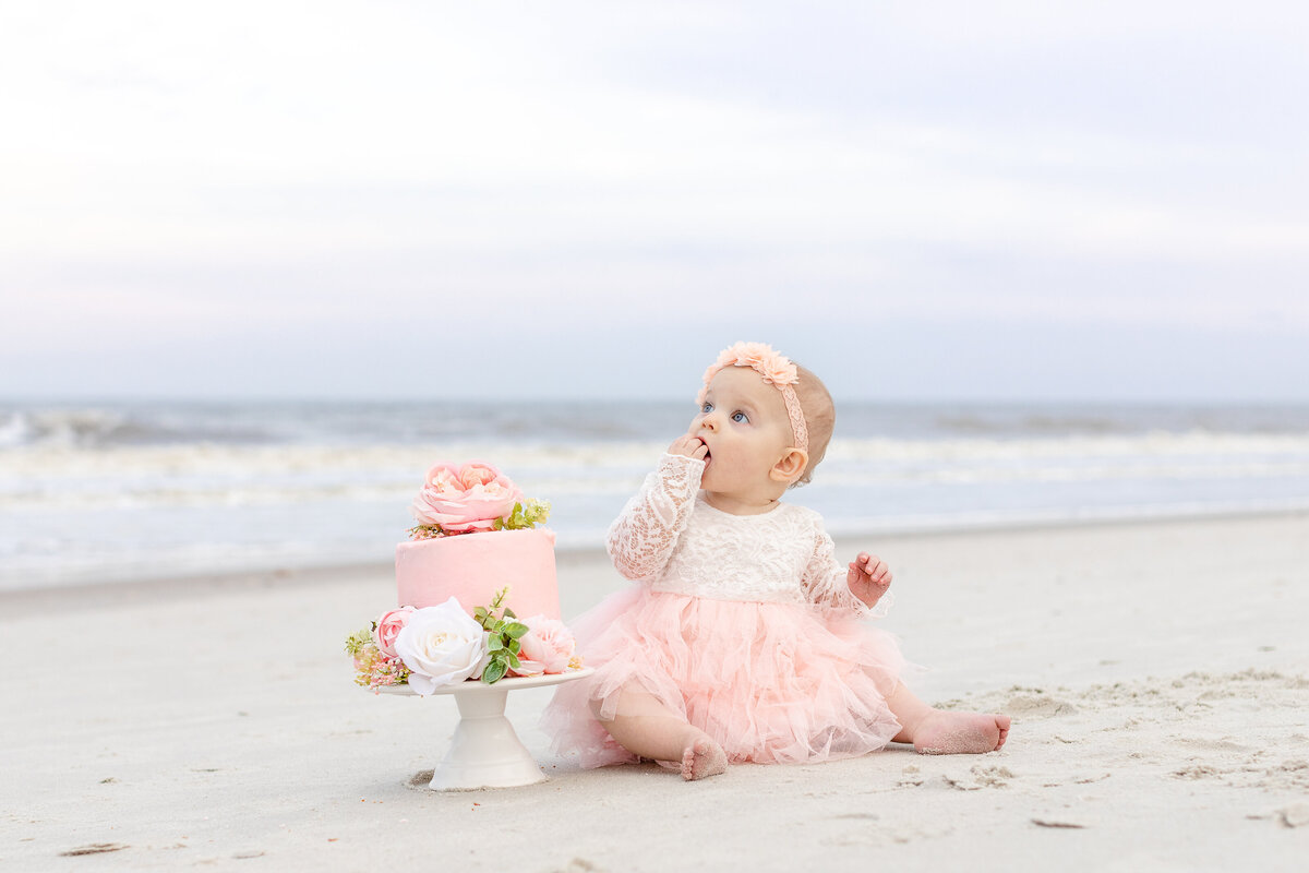 cake smash session of little girl on the beach