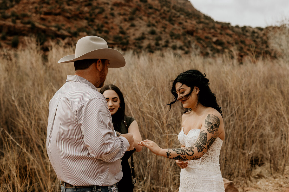 Bride and groom exchanging vows in front of the Jemez Springs red rocks