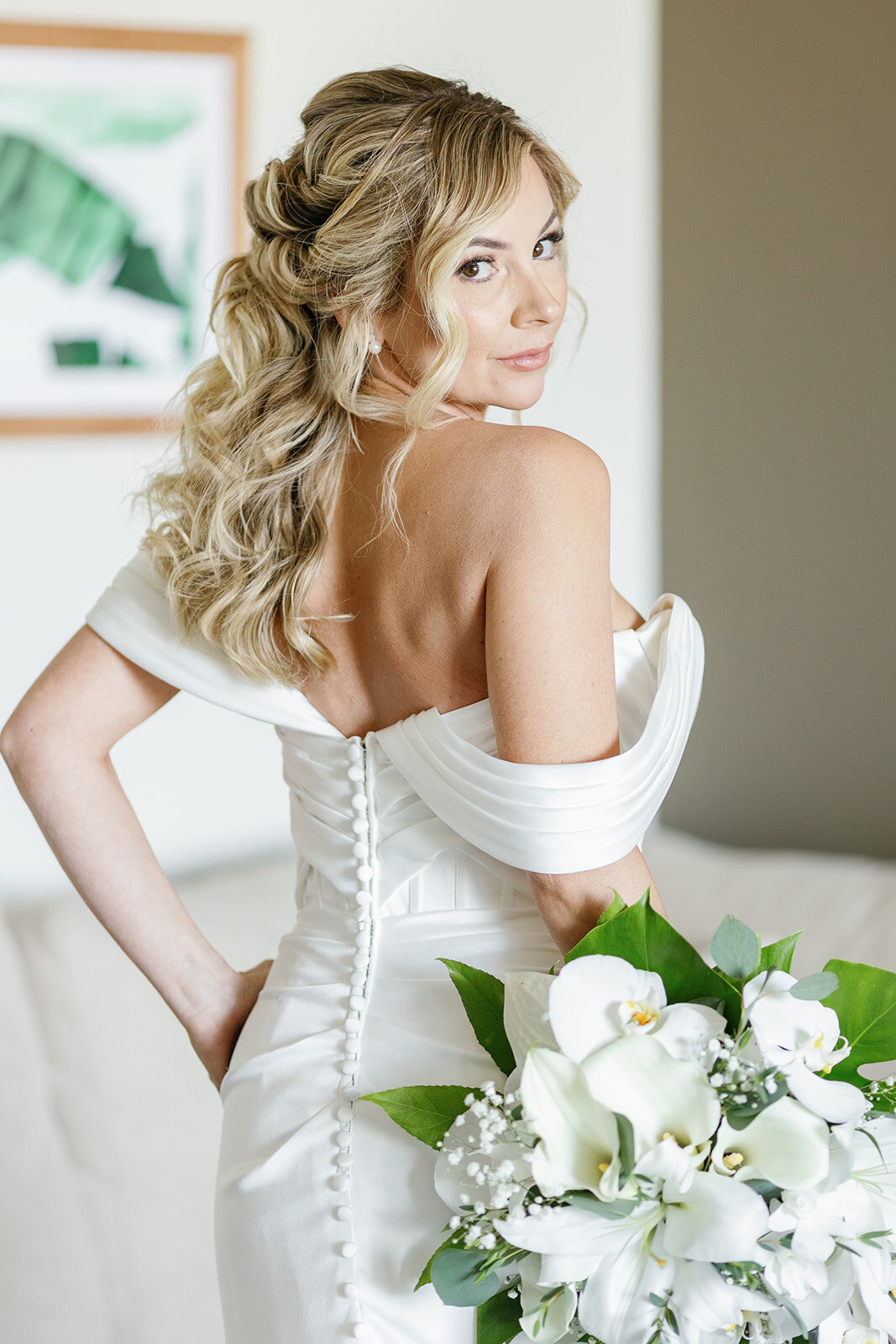 Monica in an off-the-shoulder satin wedding dress holding her bouquet, ready for her destination wedding in the Florida Keys.