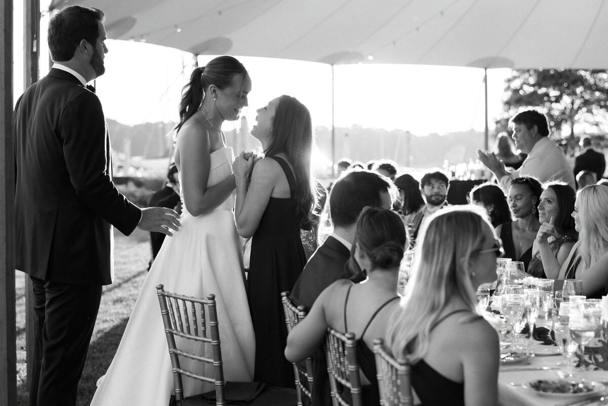 A bride holds her friend closely