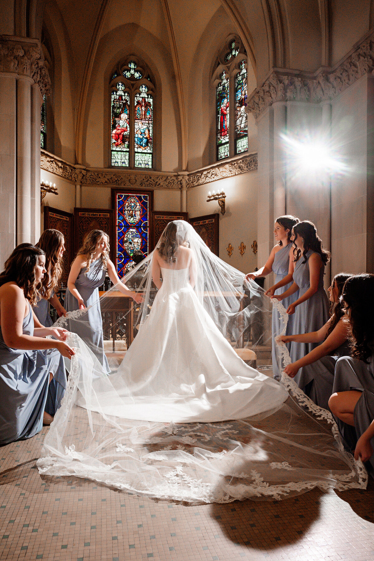 bride and bridesmaids posing for photo at st paul cathedral pittsburgh