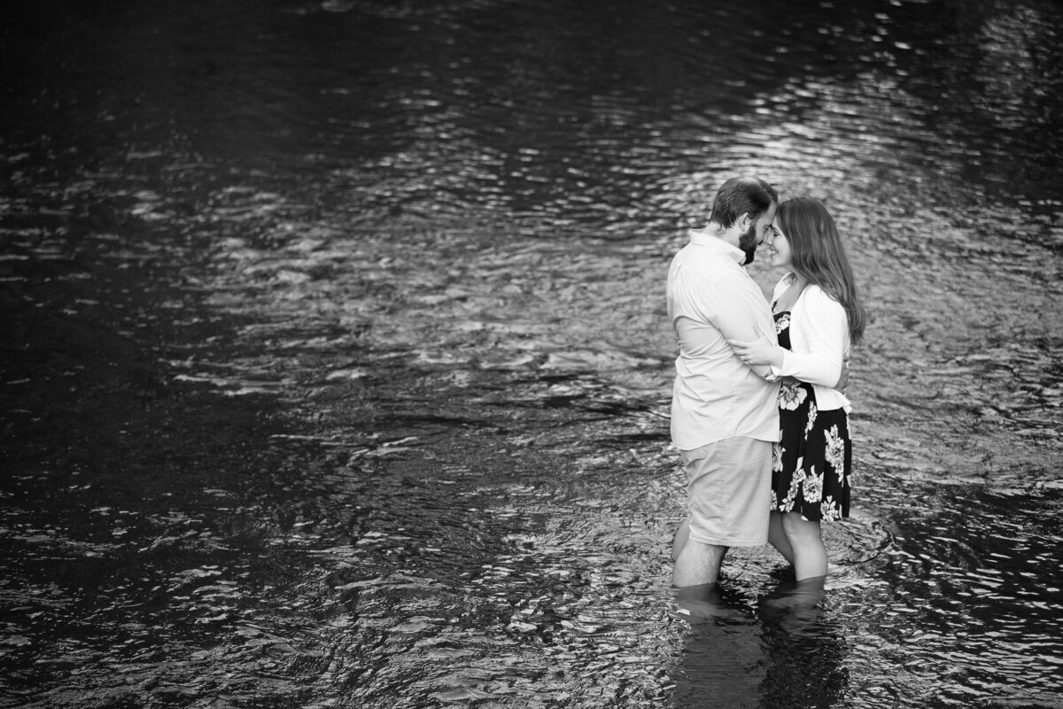 A romantic engagement portrait in a lake.