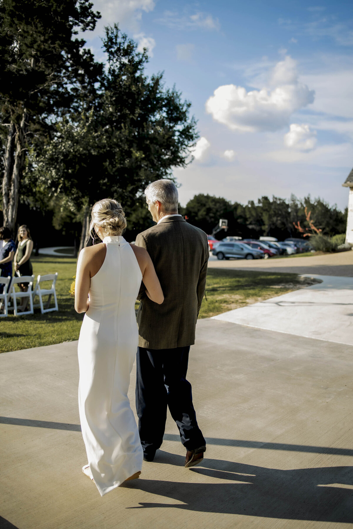 a bride and her father walk down the isle
