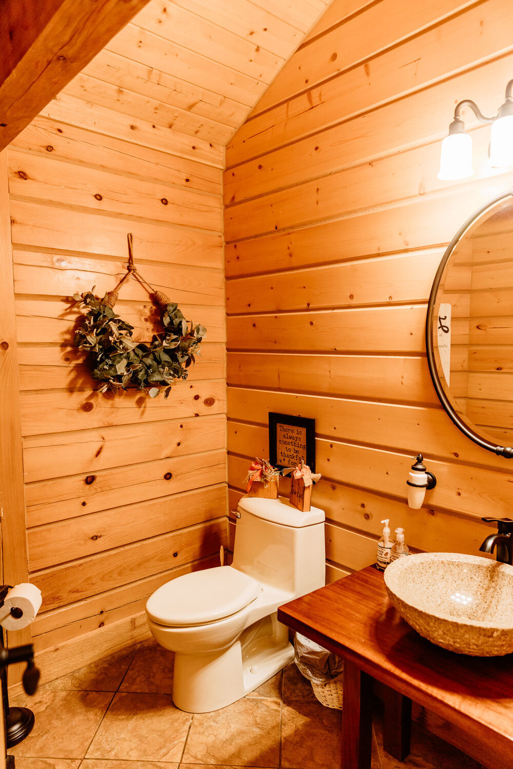 Cozy wooden bathroom with a wreath on the wall