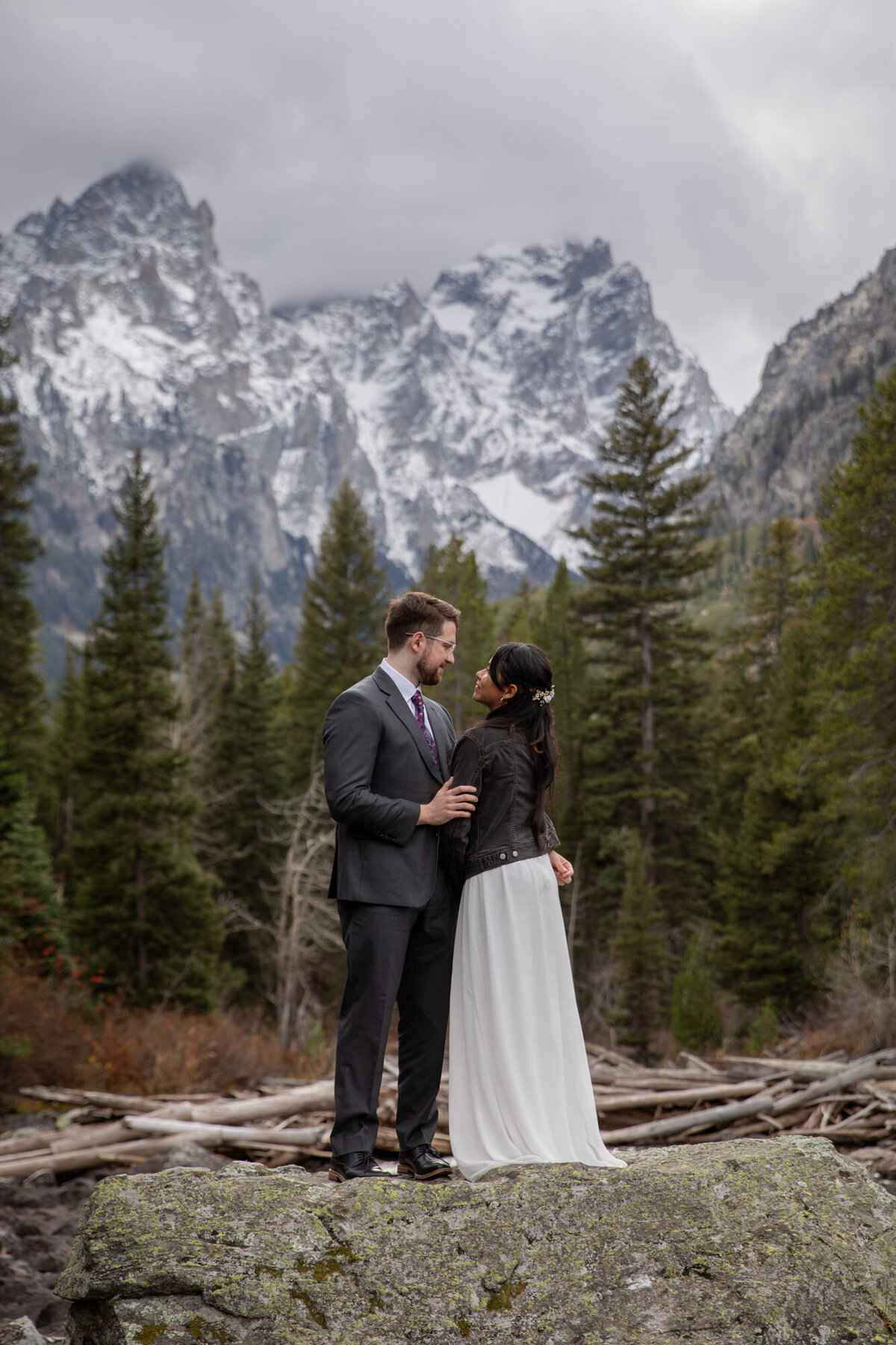 A bride and groom stand close to each other as their Wyoming elopement photographer captures their love.