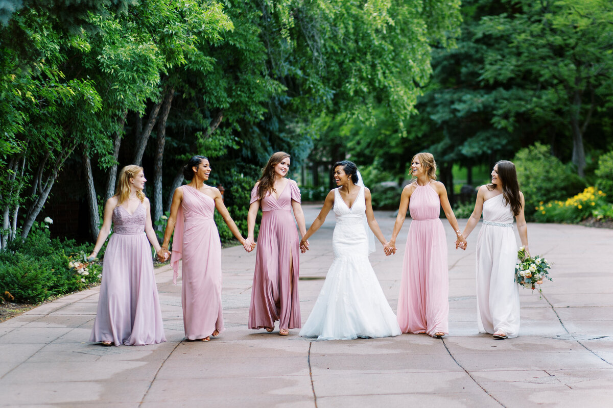 bridesmaids walking together and holding hands