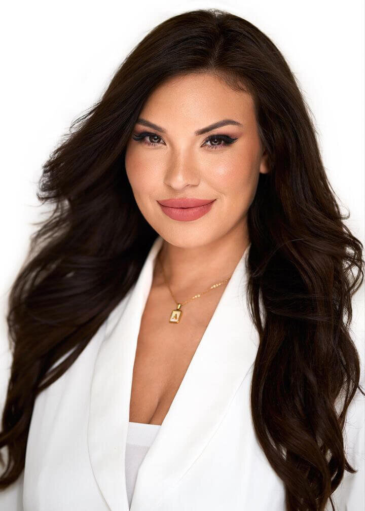 Woman with long dark waves and full glam special event makeup, photographed in studio near Austin by Mistique Makeup.