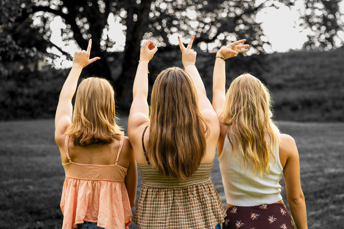 MBP Senior Team holding up hands spelling LOVE with backs to the camera in Lawrence, KS
