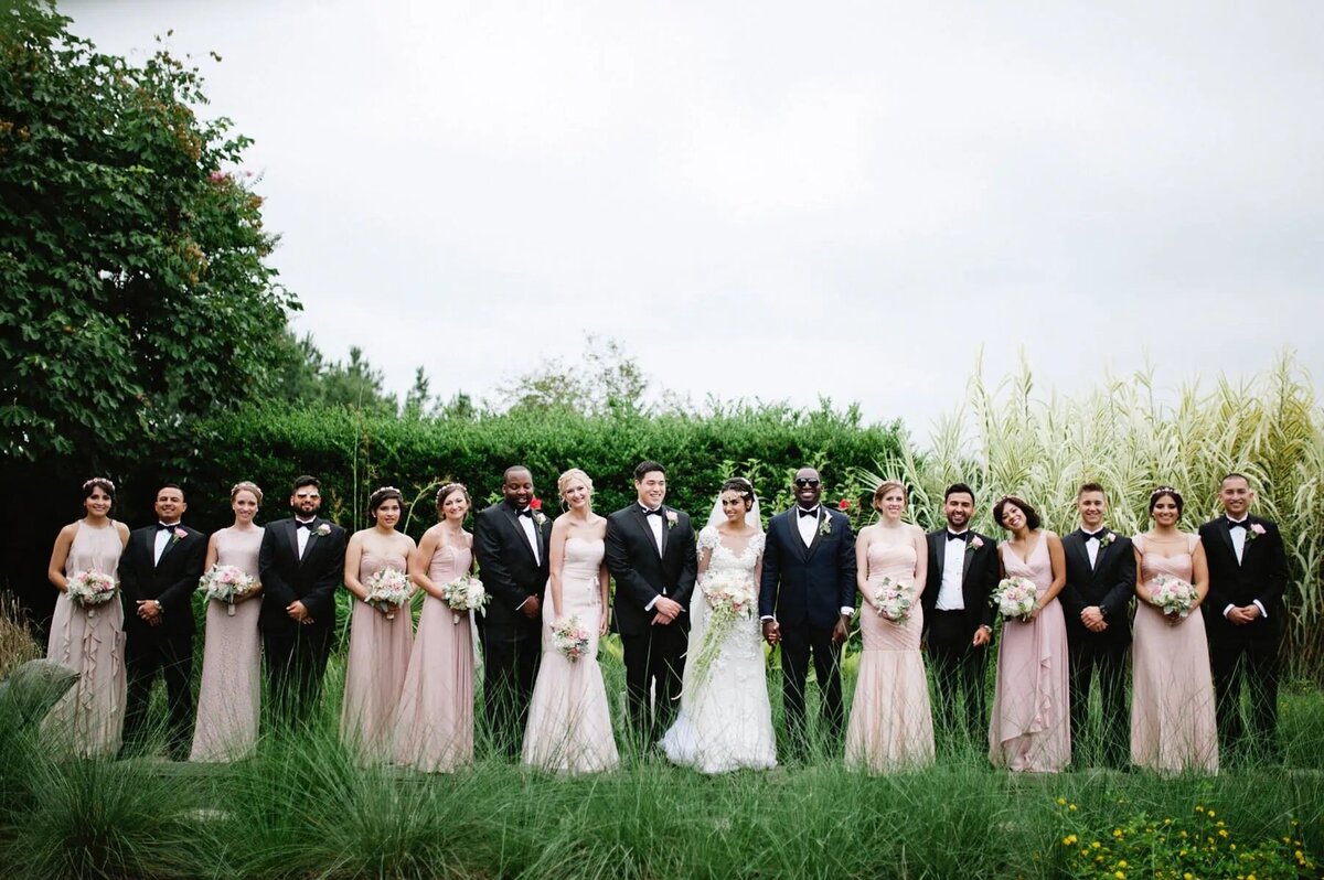 A bride and groom with their wedding parties on either side.