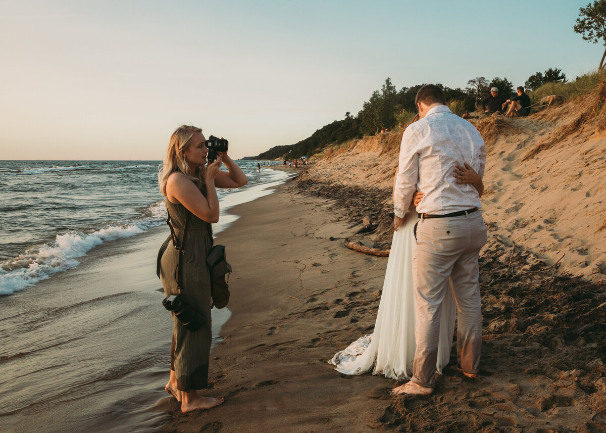 Sabrina Vanfossen photographing a couple's elopement at Saugatuck Dunes State Park in Saugatuck, Michigan.