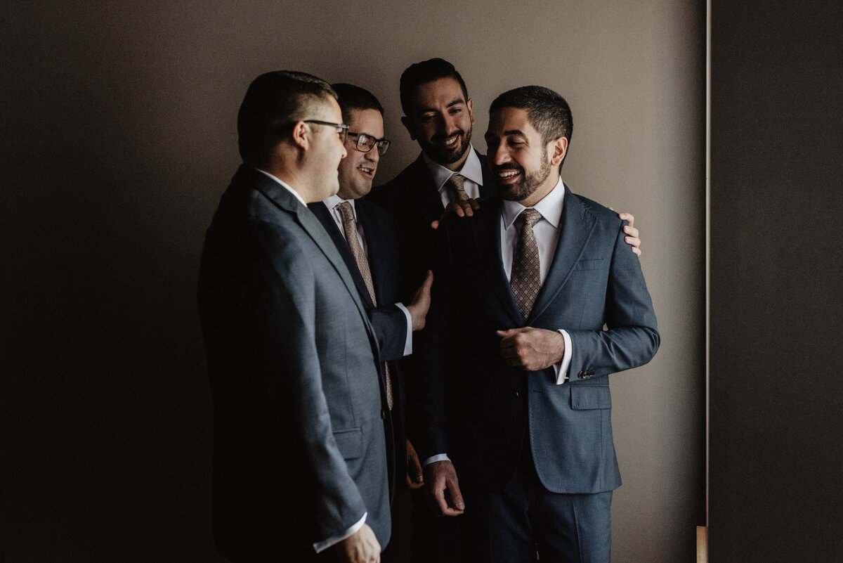 Photographers Jackson Hole capture groom with groomsmen laughing