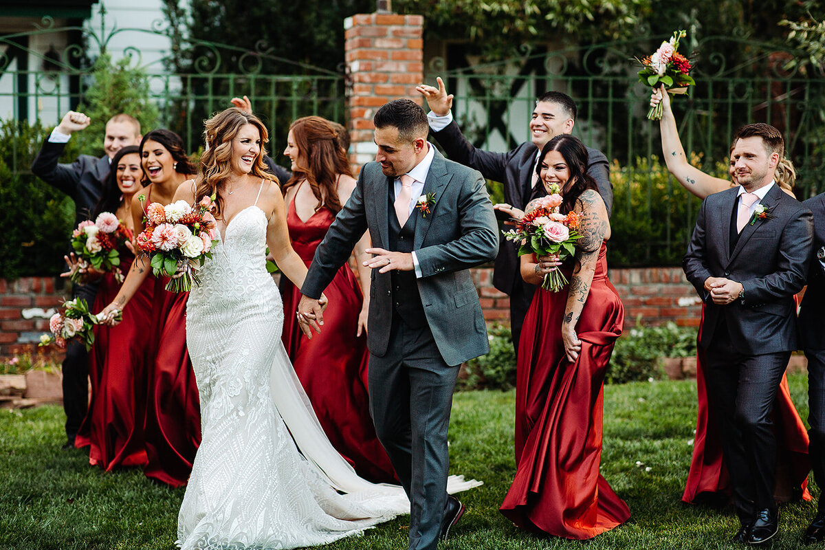 ride and groom walk with their bridesmaids and groomsmen.