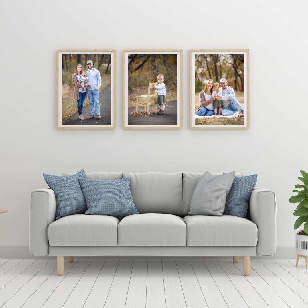 White frames containing family portraits from a photo session.