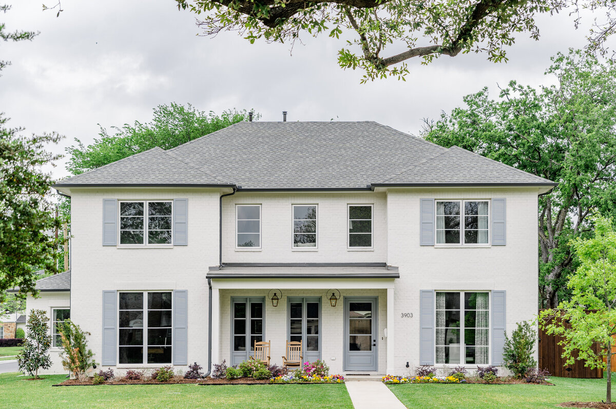 White traditional home with beautiful landscaping