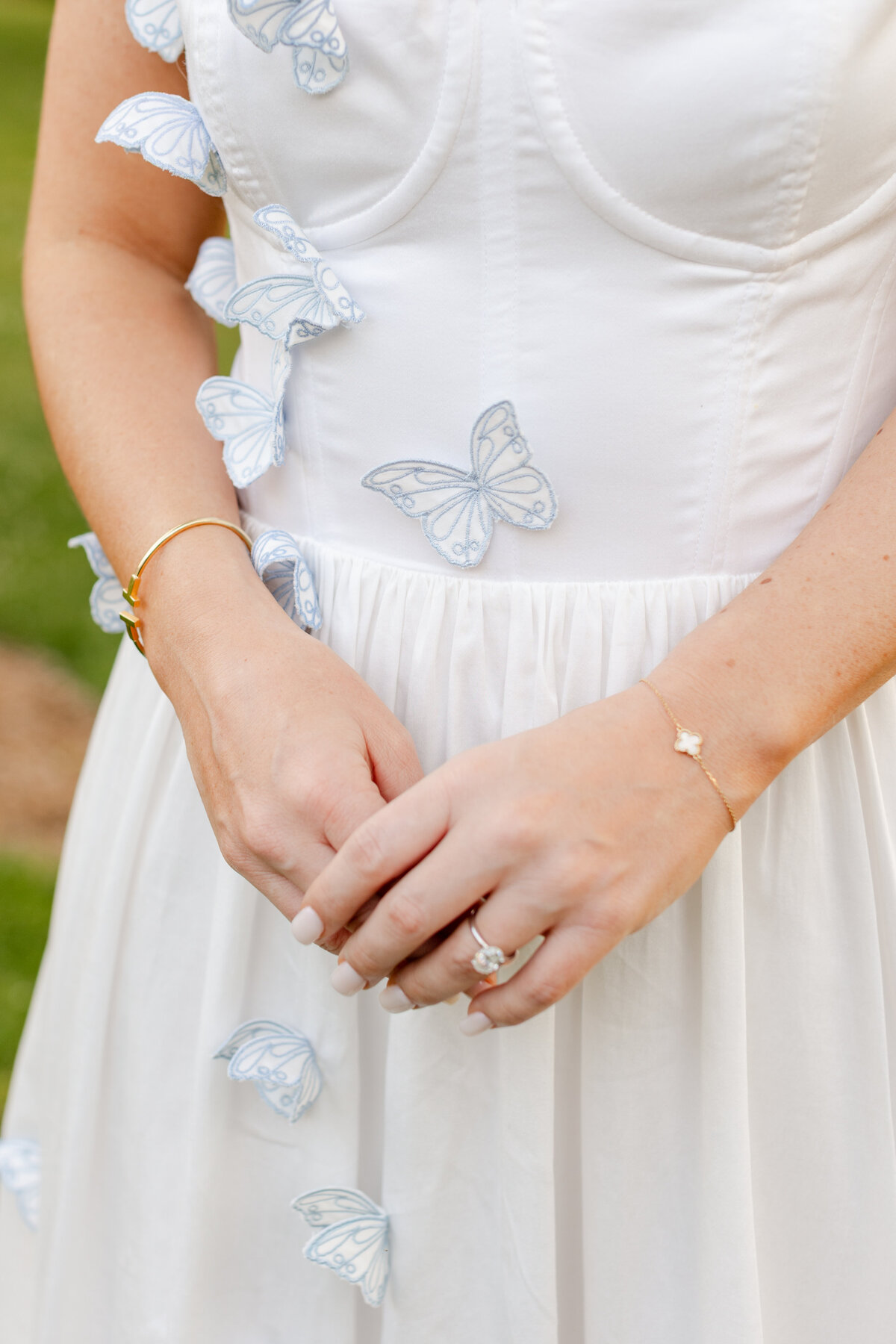 close up of the bride to be's rehearsal dress with butterfly appliqué  